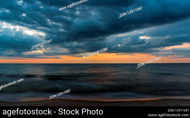 the clouds covers the sea in the evening in long exposure