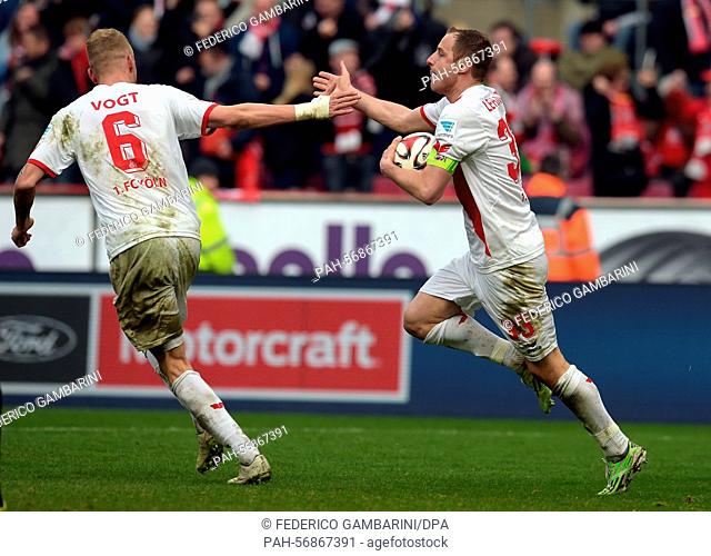 Koeln's Matthias Lehmann (R) celebrates the 1-1 goal with teammate Kevin Vogt (L) during the German Bundesliga soccer match between 1