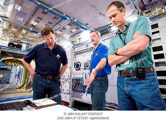 Canadian Space Agency astronaut Chris Hadfield (center), Expedition 34 flight engineer and Expedition 35 commander; along with Russian cosmonaut Roman Romanenko...