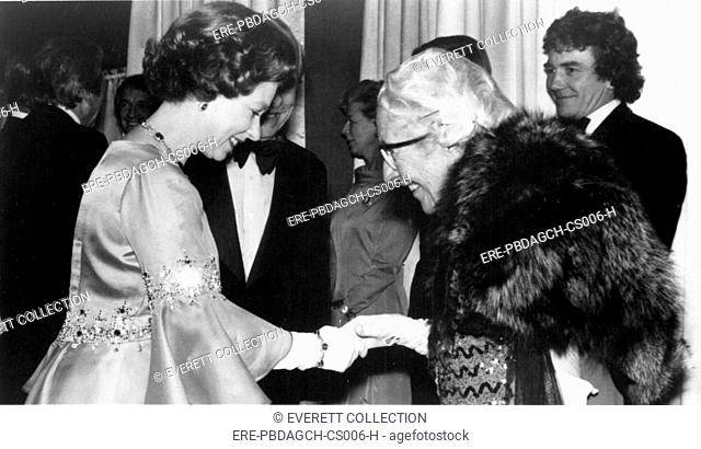 Queen Elizabeth II & Dame Agatha Christie at Royal performance of MURDER ON THE ORIENT EXPRESS, 1974. Albert Finney is in the background