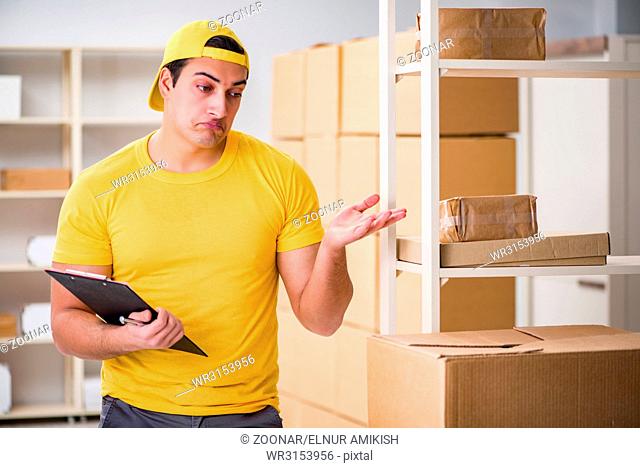 Man working in postal parcel delivery service office