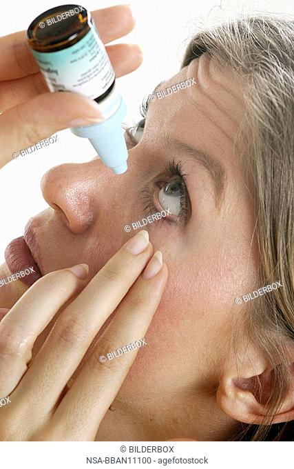 Woman with eye drops