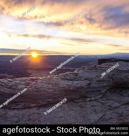 View over the Mesa Arch at sunrise, Colorado River Canyon with the La Sal Mountains in the back, view at Grand View Point Trail, Island in the Sky