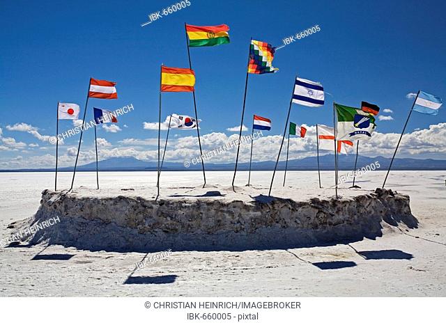 Flags in the wind, salt hotel Hotel de Sal Playa Blanca, Altiplano, salt lake Salar de Uyuni, Bolivia, South America