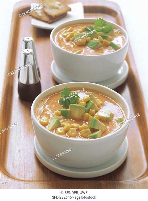Sweetcorn and avocado soup in bowls on tray