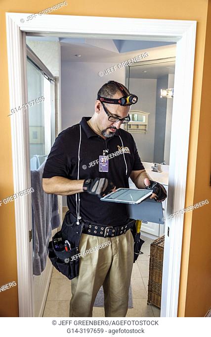 Florida, Miami Beach, North Beach, Hispanic, Man, home inspector, using tablet, inspecting condo apartment unit flat