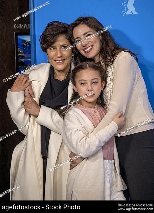 20 February 2023, Berlin: Montserrat Maranon, actress (l-r), Naima Senties, actress and Lila Aviles, director, embrace at the photocall of the film ""Totem"" at...