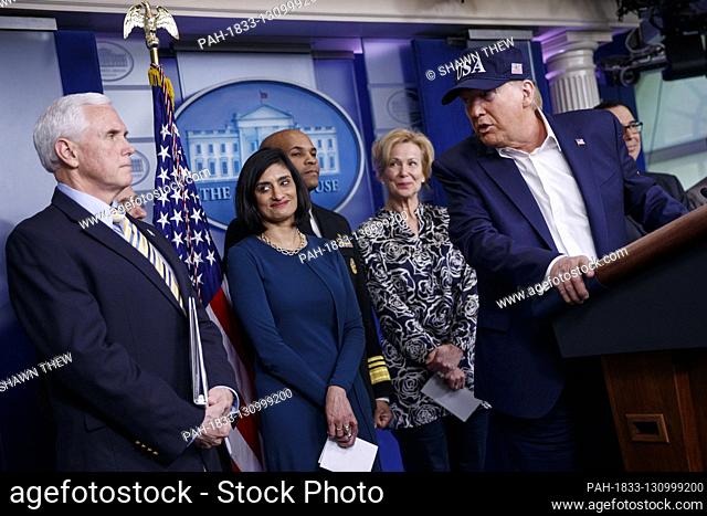 US President Donald J. Trump, with Vice President Mike Pence (L), administrator of the Centers for Medicare and Medicaid Services Seema Verma (2-L)