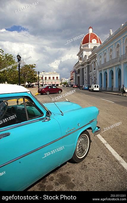 Old American car in front of the City Hall at Jose Marti Park at Plaza de Armas at the historic center, Cienfuegos, Cienfuegos Province, Cuba, West Indies