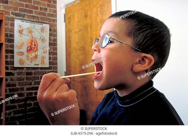 Pediatrician Examines Young Boy's Throat