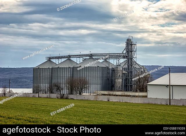 Landscape with modern agricultural Silo. Set of storage tanks cultivated agricultural crops processing plant