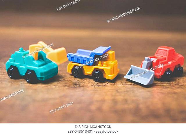 Toy construction machinery on wooden background