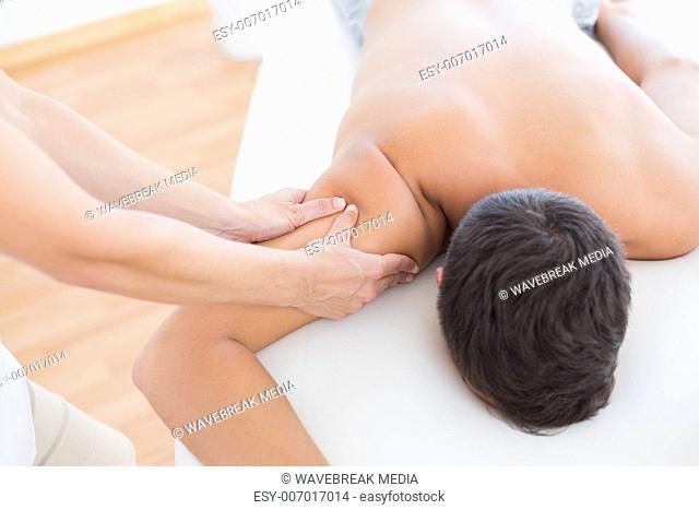 Physiotherapist doing arm massage to her patient