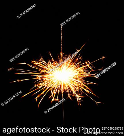 Christmas sparkler isolated on black background. Bengal fire for design