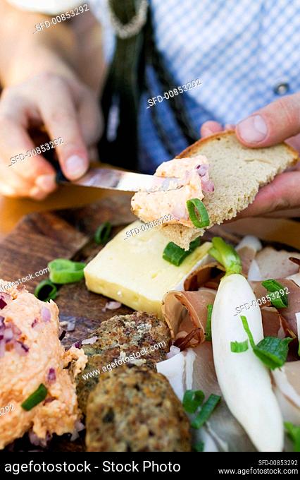 Spreading obatzda (Bavarian Camembert spread) on bread