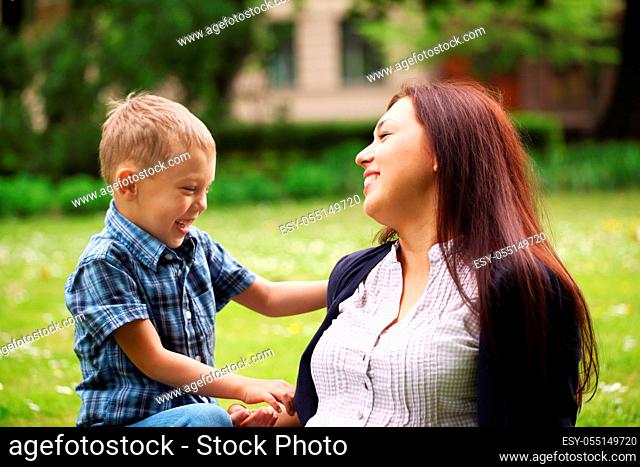 Young and happy mother with her son in the park