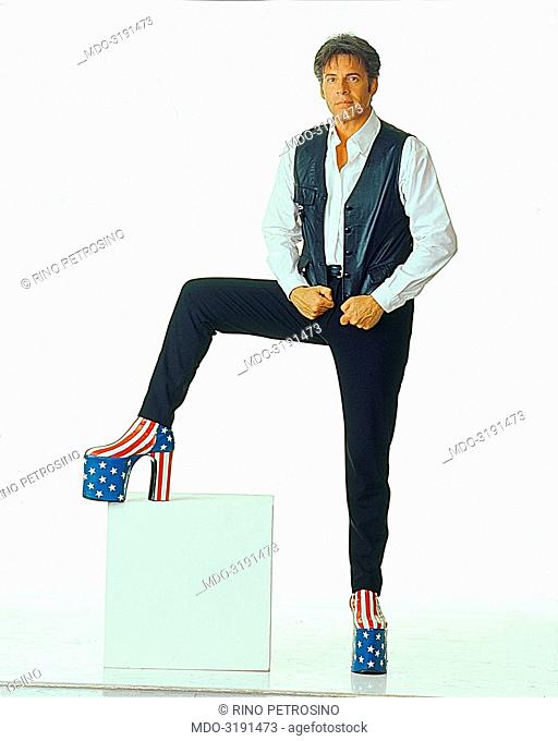 Italian song writer Claudio Baglioni (Claudio Enrico Paolo Baglioni) posing with American wedge-boots for a photo shoot for TV show 'Anima mia' on Raidue