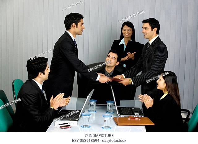 Executive handing a file