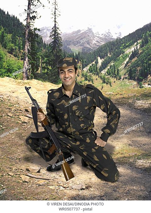 Indian army soldier Ak-47 machine gun in hand mountain in background MR