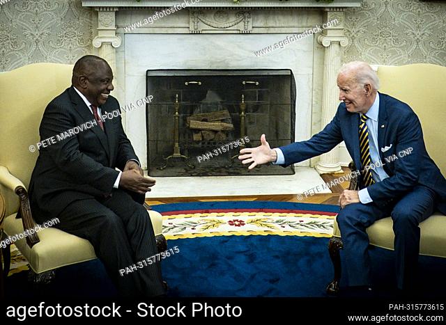 United States President Joe Biden offers his hand to President Cyril Ramaphosa of South Africa during a bilateral meeting in the Oval Office of the White House...