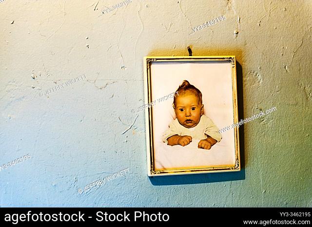Framed baby picture from the 1950s hanging on the wall