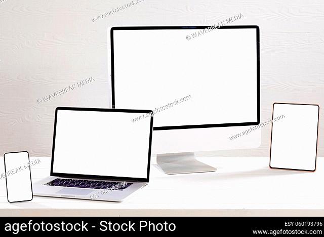 Composition of desktop computer, laptop, tablet and smartphone with copy space on white background