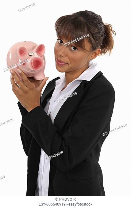 Businesswoman holding piggy-bank