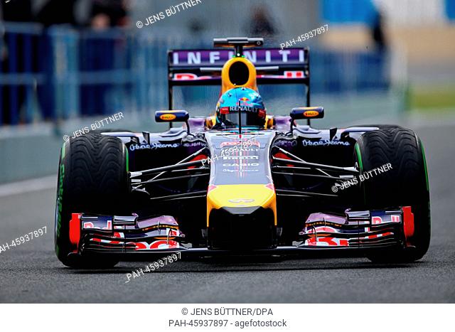 German Formula One driver Sebastian Vettel of Red Bull steers his car through the pit lane during the training session for the upcoming Formula One season at...
