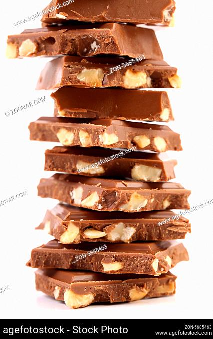 Tasty morsel of milk chocolate with nuts. White background