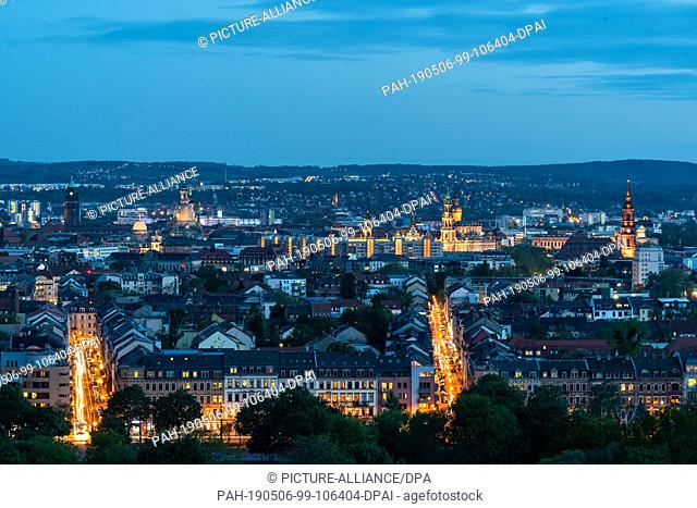06 May 2019, Saxony, Dresden: Panoramic view in the evening over the new town to the historical old town with the town hall (l-r)