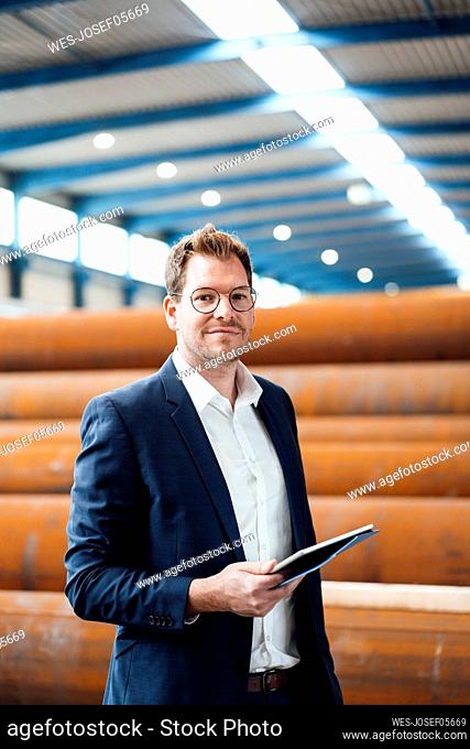 Male professional with digital tablet at warehouse