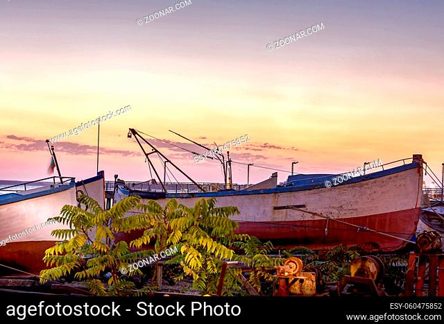 Pomorie, Bulgaria beachfront sea panorama with fishing boats in the town and seaside resort on Black sea, sunset view