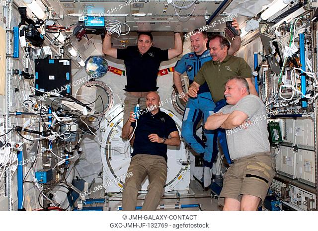 Five of the six Expedition 36 crew members are pictured in the International Space Station's Kibo laboratory during a daily planning conference