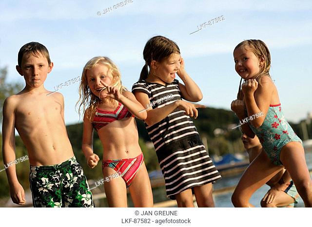 Five children on the jetty, Lake Woerthsee, Upper Bavaria, Bavaria, Germany