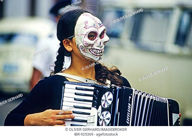 Accordion player wearing a skull or death mask during the Day of the Dead Festival, held on All Saints' Day or All Hallows in Patzcuaro, Michoacan, Mexico