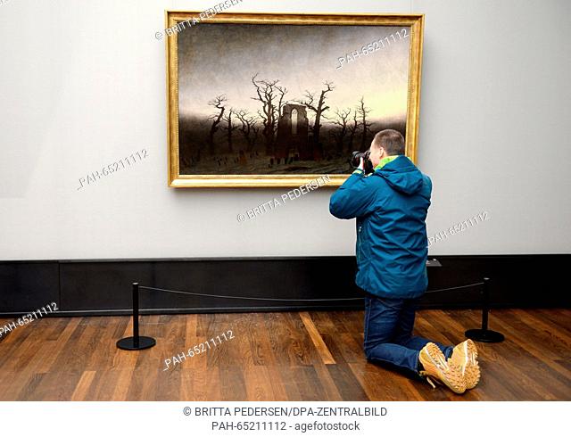 A journalist photographs the restored 'The Abbey in the Oakwood' by painter Caspar David Friedrich (1774 - 1840) in the Alte Nationalgalerie in Berlin, Germany