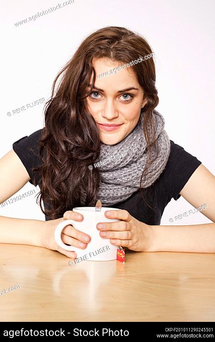 A beautiful young woman, lady, girl, cold, runny nose, headache, cup of tea, scarf  (CTK Photo/Rene Fluger) MODEL RELEASED, MR