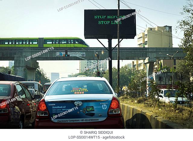 India, Maharashtra, Mumbai. A monorail undergoing safety trials over a busy road junction