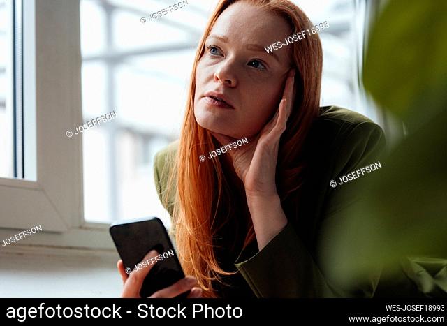 Worried woman with smart phone