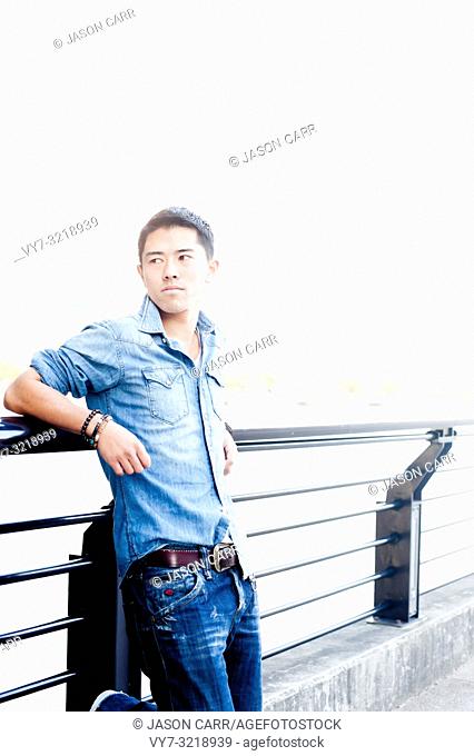 Asian male model poses for pictures in the cityscape