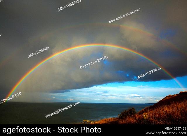 Rainbow in front of storm cloud on Omaha Beach in Normandy