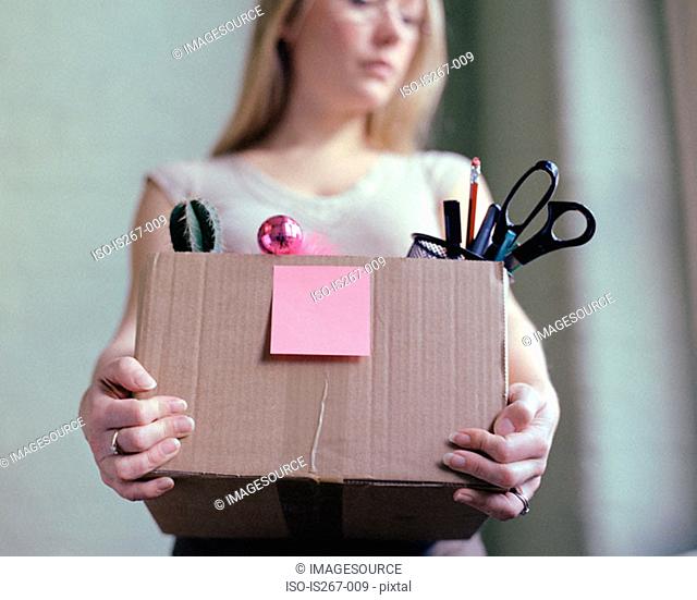 Woman carrying box of stationery
