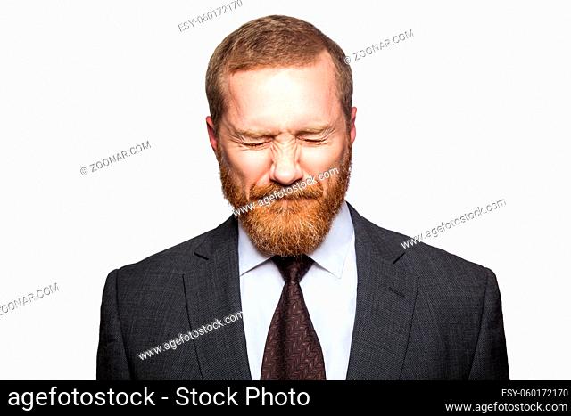 Unhappy sad businessman with closed eyes. isolated on white, looking at camera.