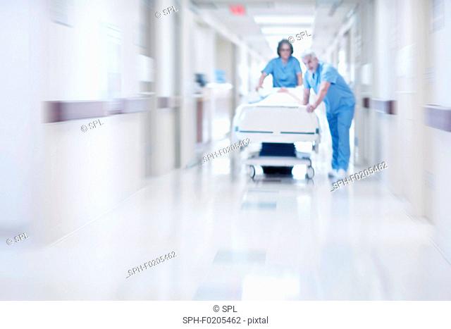 Two doctors pushing hospital bed