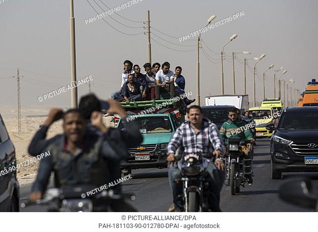 03 November 2018, Egypt, New Minya: People mount a truck as they head to the Coptic graves during the funeral of the victims who were killed during a gun attack...