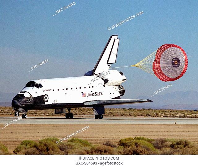 A drag chute slows the shuttle Endeavour after landing on runway 22 at Edwards, California, to complete the highly successful STS-68 mission dedicated to radar...