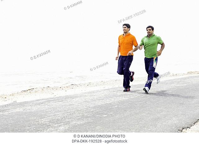 Vijender Singh and Sushil Kumar running on the road India Asia