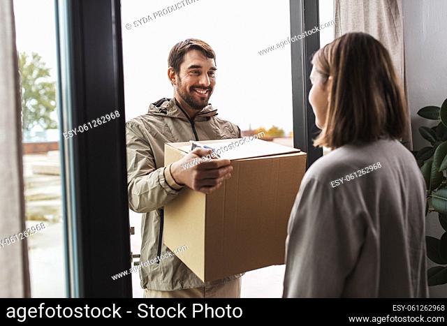 delivery man with parcel box and customer at home