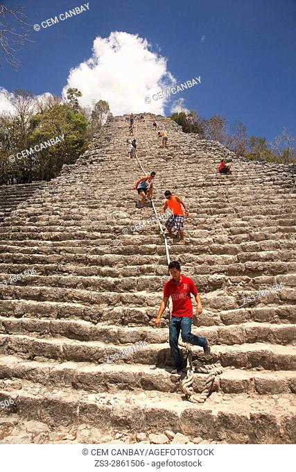Tourists climbing up to the Nohoch Mull Pyramid at the Prehispanic Mayan city of Coba Archaeological Site, Quintana Roo, Mexico , Central America