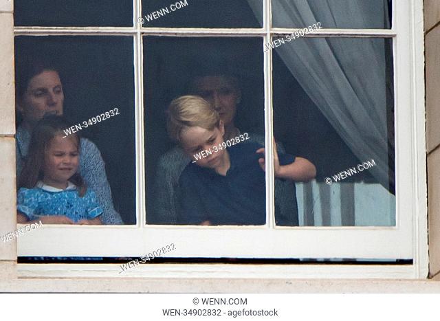 Incredibly cute photos of Princess Charlotte and Prince George show the two young royals having fun at a window in Buckingham Palace